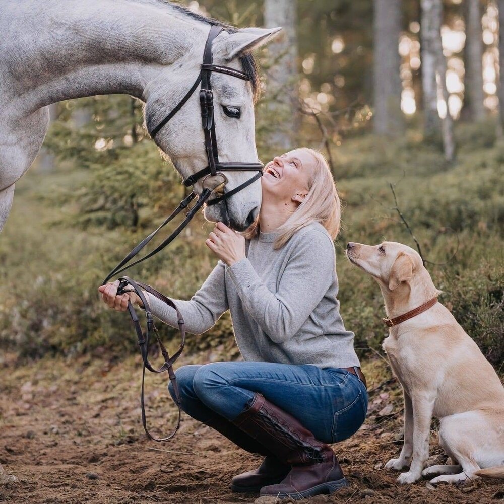 Milla Törmälä outdoors with her horse and dog